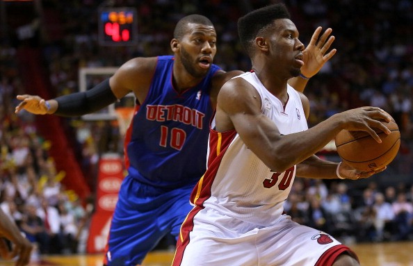 Norris Cole #30 of the Miami Heat drives against Greg Monroe #10 of the Detroit Pistons 