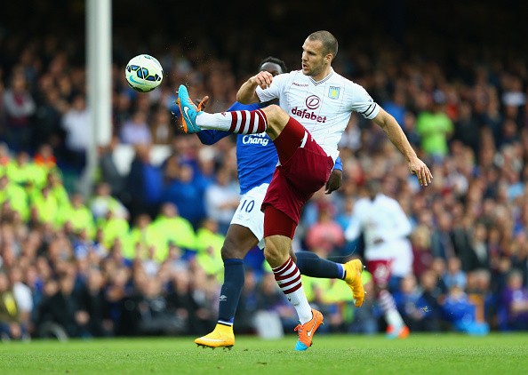 Ron Vlaar of Aston Villa controls the ball during the Barclays Premier League