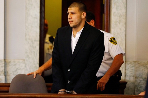 Aaron Hernandez is escorted into the courtroom of the Attleboro District Court