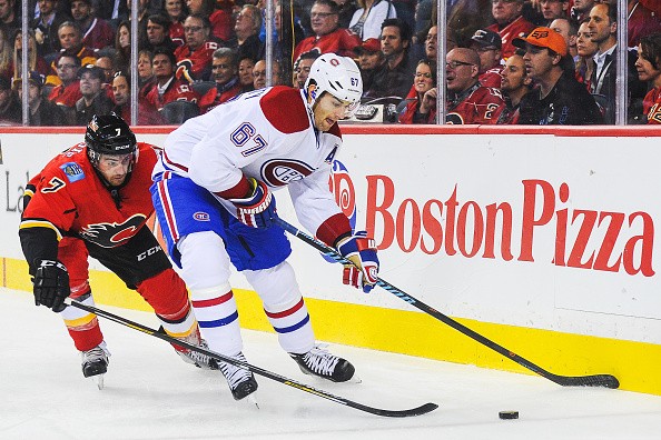 T.J. Brodie #7 of the Calgary Flames chases Max Pacioretty #67 of the Montreal Canadiens