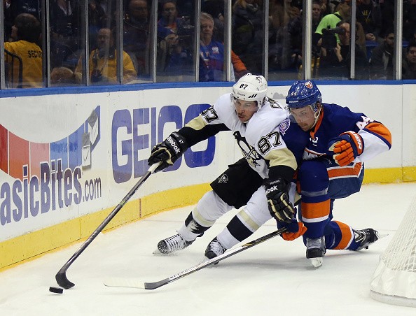 Calvin de Haan #44 of the New York Islanders holds off Sidney Crosby #87 of the Pittsburgh Penguins 