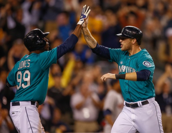 Michael Saunders #55 (R) of the Seattle Mariners