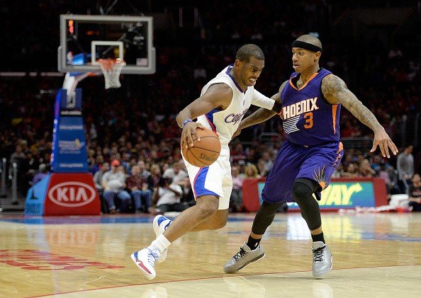 Chris Paul #3 of the Los Angeles Clippers attempts to dribble around Isaiah Thomas #3 of the Phoenix Suns