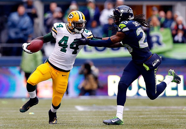 James Starks #44 of the Green Bay Packers gives Richard Sherman #25 of the Seattle Seahawks
