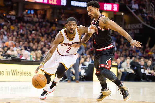 Kyrie Irving #2 of the Cleveland Cavaliers drives around Derrick Rose #1 of the Chicago Bulls