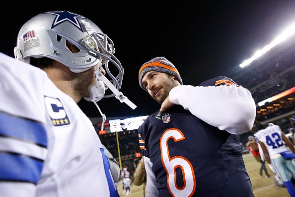 Tony Romo #9 of the Dallas Cowboys meets with Jay Cutler #6 of the Chicago Bears
