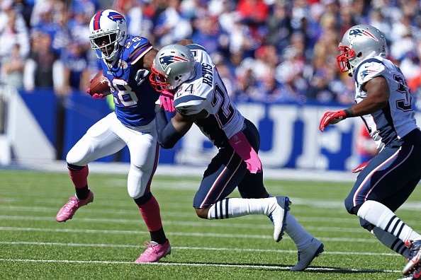 C.J. Spiller #28 of the Buffalo Bills is brought down by Darrelle Revis 