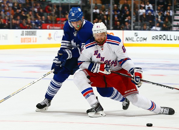 James van Riemsdyk #21 of the Toronto Maple Leafs battles with Rick Nash 