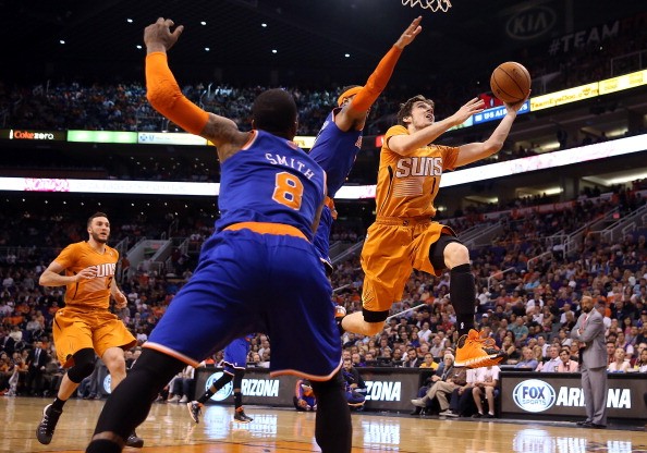 Goran Dragic #1 of the Phoenix Suns lays up a shot past Carmelo Anthony