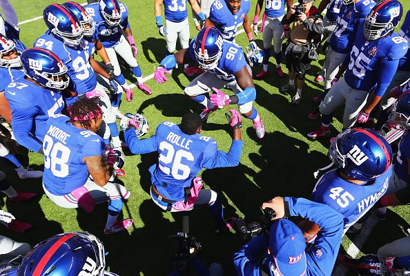 Antrel Rolle #26, and Jason Pierre-Paul #90 of the New York Giants
