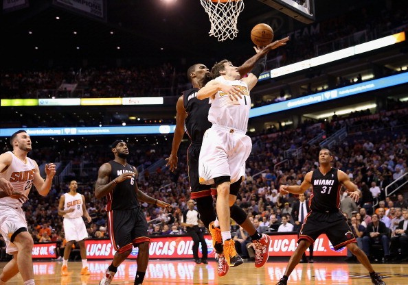 Goran Dragic #1 of the Phoenix Suns attempts a lay up against Chris Bosh #1 of the Miami Heat 