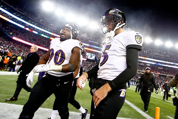 Pernell McPhee #90 and Joe Flacco #5 of the Baltimore Raven