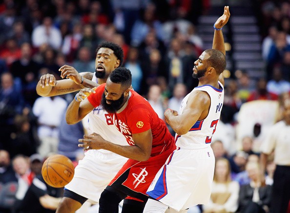 James Harden #13 of the Houston Rockets is fouled by Chris Paul #3 of the Los Angeles Clippers