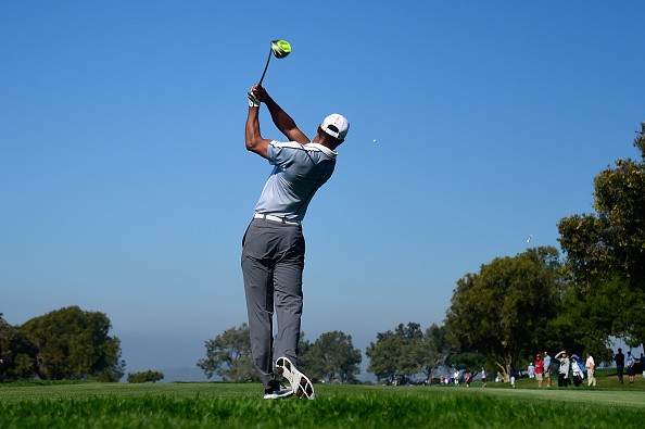 Tiger Woods plays his tee shot on the 15th hole