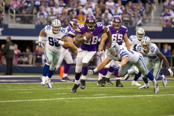 Adrian Peterson (28) in action,