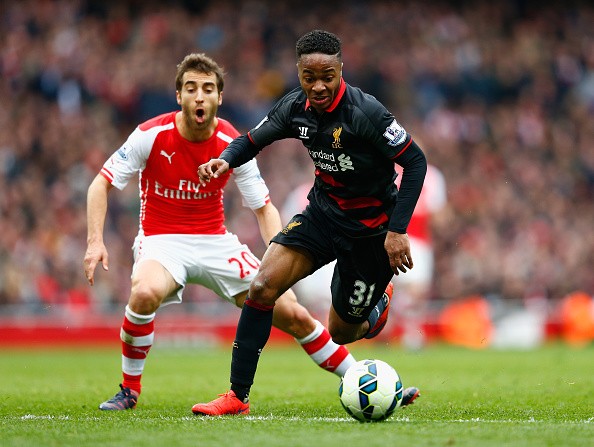 Raheem Sterling of Liverpool goes past Mathieu Flamini