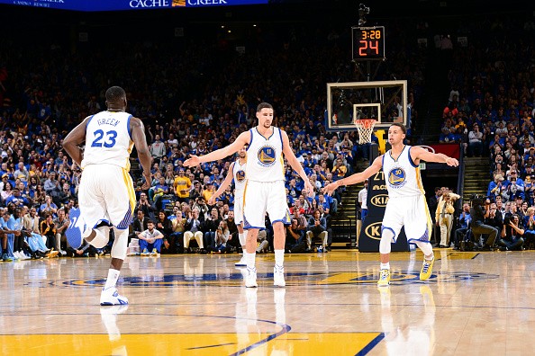 Klay Thompson #11 high fives Stephen Curry #30 and Draymond 