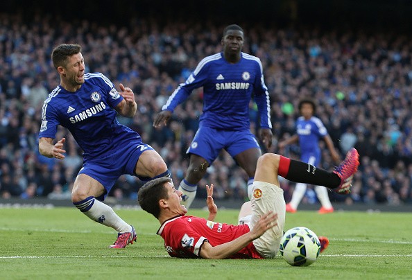 Ander Herrera of Manchester United clashes with Gary Cahill of Chelsea