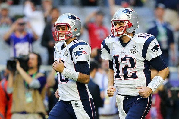 Jimmy Garoppolo #10 and Tom Brady #12 of the New England Patriots 