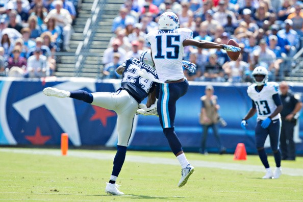 Justin Hunter #15 of the Tennessee Titans has a pass knocked away by Morris Claiborne