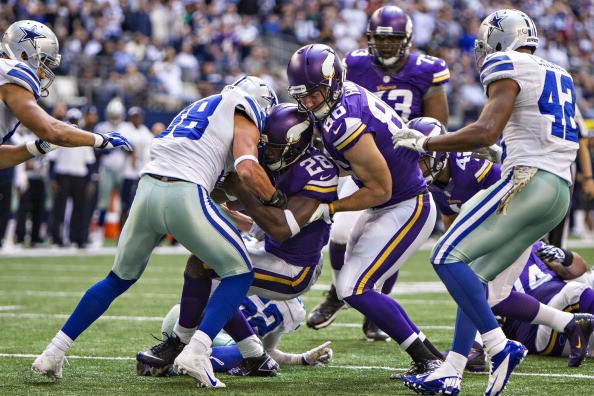 Adrian Peterson #28 is helped into the end zone