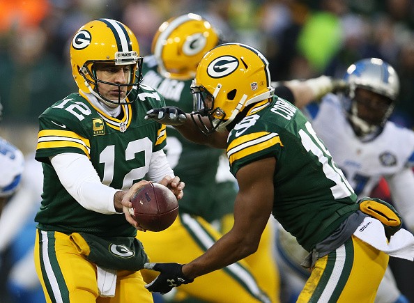 Aaron Rodgers #12 looks to hand off to Randall Cobb #18 