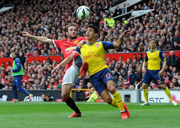 Alexis Sanchez of Arsenal is challenged by Juan Mata