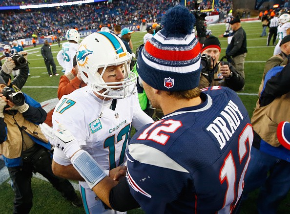 Tom Brady #12 of the New England Patriots and Ryan Tannehill #17 of the Miami Dolphins