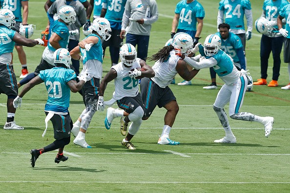 Lamar Miller #26 of the Miami Dolphins runs 