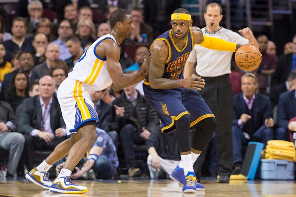 Harrison Barnes #40 of the Golden State Warriors puts pressure on LeBron James #23 of the Cleveland Cavaliers 