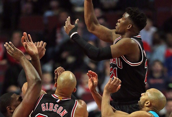 Jimmy Butler #21 of the Chicago Bulls goes up a shot over teammate Taj Gibson #22 