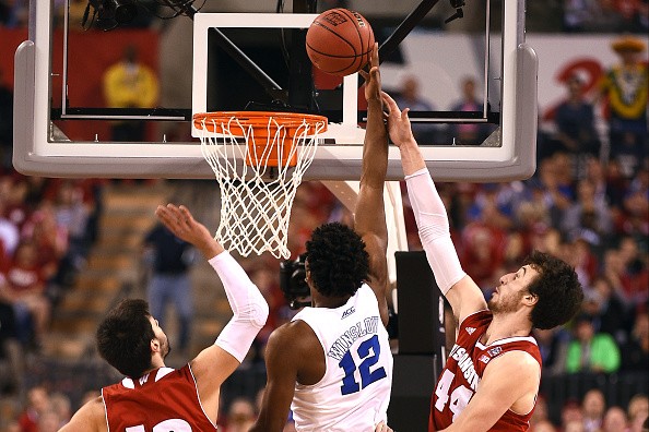 Frank Kaminsky #44 of the Wisconsin Badgers defends a shot by Justise Winslow #12 of the Duke Blue Devils 