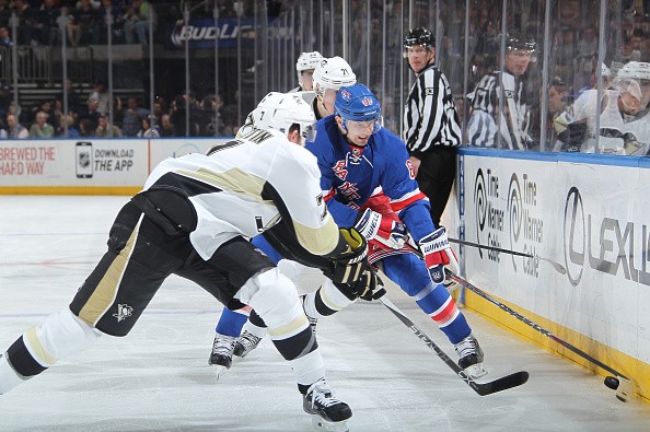 Rick Nash #61 of the New York Rangers battles for the puck along the boards against Paul Martin #7 and Evgeni Malkin #71 of the Pittsburgh Penguins