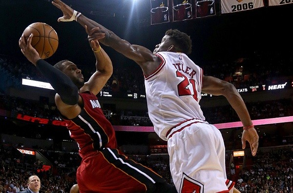 Dwyane Wade #3 of the Miami Heat is defended by Jimmy Butler #21 of the Chicago Bulls 