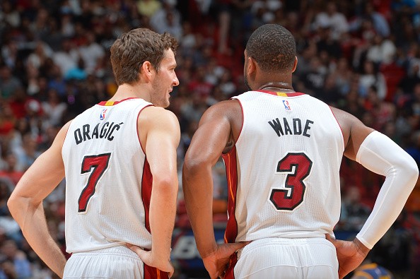 Goran Dragic #7 and Dwyane Wade #3 of the Miami Heat look on against the Cleveland Cavaliers 