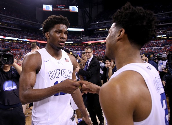 Justise Winslow #12 of the Duke Blue Devils celebrates with Quinn Cook 