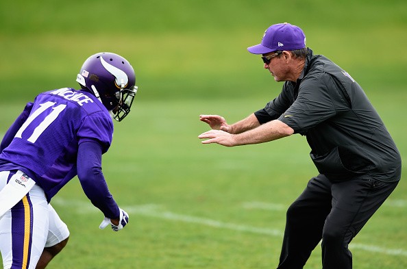 Head coach Mike Zimmer of the Minnesota Vikings blocks Mike Wallace #11 