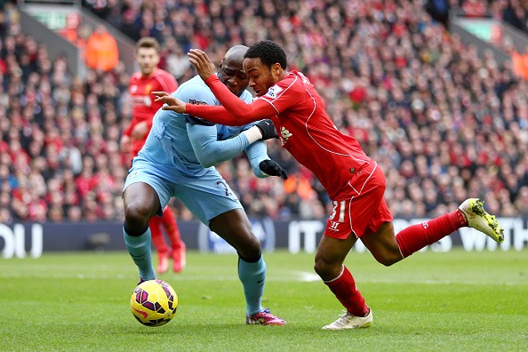 Raheem Sterling of Liverpool takes on Eliaquim Mangala of Manchester City 