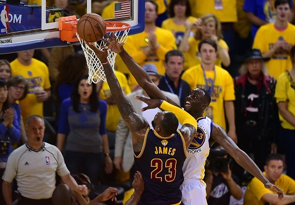 Draymond Green of the Golden State Warriors blocks an attempt by LeBron James of the Cleveland Cavaliers 