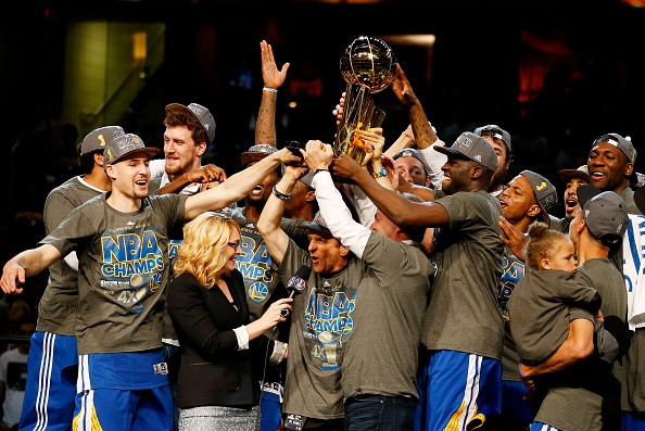 The Golden State Warriors celebrate with the Larry O'Brien NBA Championship Trophy