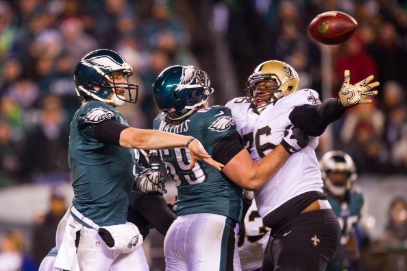 Nick Foles #9 of the Philadelphia Eagles drops back to pass as teammate Evan Mathis #69 