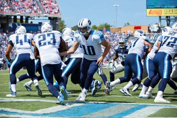 Jake Locker #10 hands off the ball to Shonn Greene #23 of the Tennessee Titans