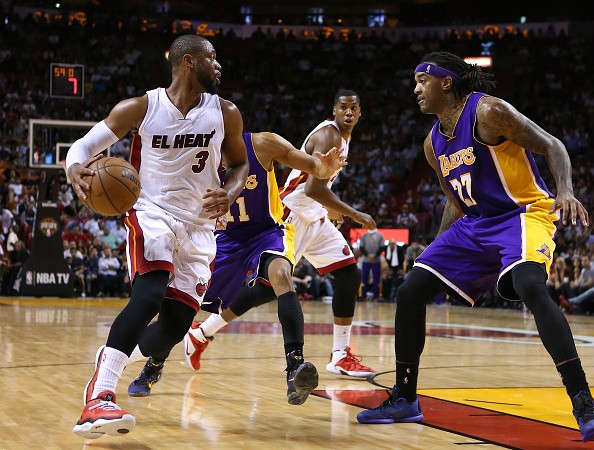 The Miami Heat's Dwyane Wade (3) drives against the Los Angeles Lakers' Wesley Johnson 