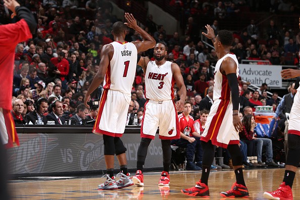 Dwyane Wade #3 of the Miami Heat celebrates with his teammates during the game against the Chicago Bulls