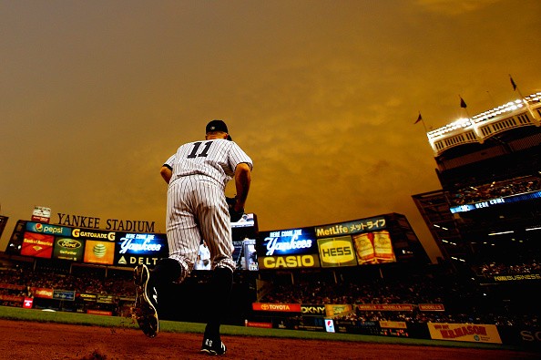 Brett Gardner #11 of the New York Yankees runs onto the field in the first inning against the Philadelphia Phillies 