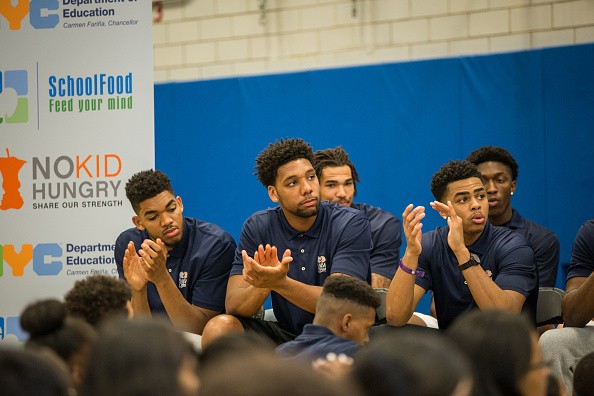 Karl-Anthony Towns, Jahlil Okafor and D'Angelo Russell interact with a group of children during an NBA Fit Event
