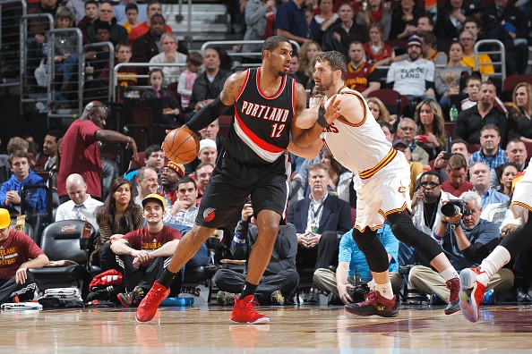 LaMarcus Aldridge #12 of the Portland Trail Blazers handles the ball against Kevin Love #0 of the Cleveland Cavaliers 