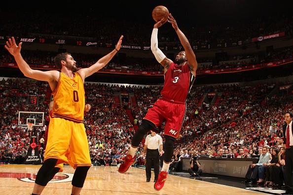 Dwyane Wade #3 of the Miami Heat shoots against Kevin Love #0 of the Cleveland Cavaliers 