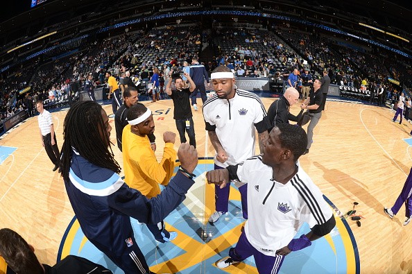 Ty Lawson #3 and Kenneth Faried #35 of the Denver Nuggets greets DeMarcus Cousins #15 and Darren Collison #7 of the Sacramento Kings