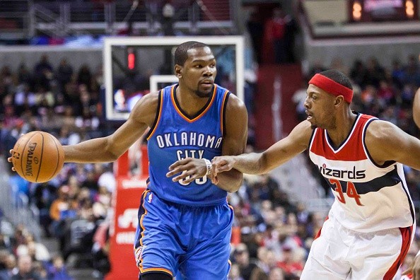 Kevin Durant (35) of Oklahoma City Thunder controls the ball against Paul Pierce (34) of the Washington Wizards 